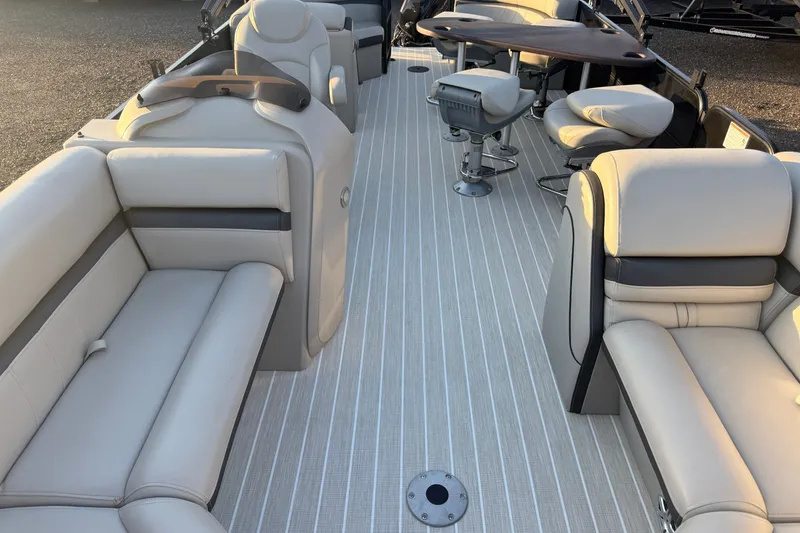 Slide: The Image of Luxurious interior of 2019 South Bay 224E pontoon boat with plush seating and table. - 19