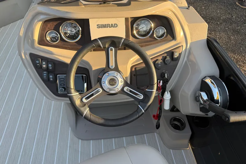 Slide: The Image of Steering console of a 2019 South Bay 224E boat with Simrad electronics. - 12