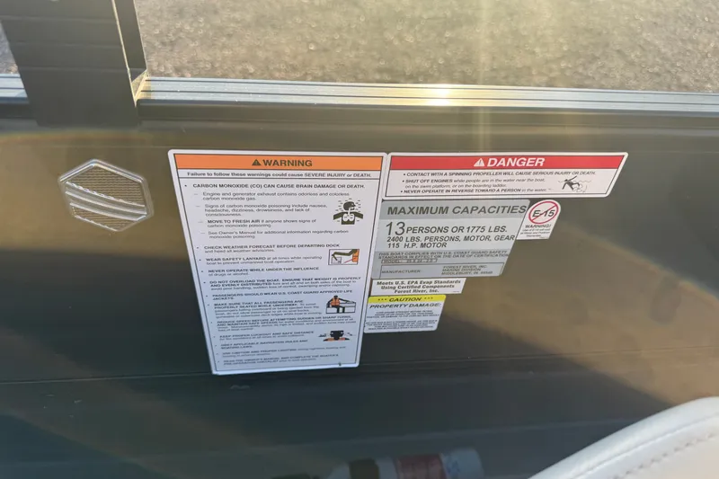 Slide: The Image of Safety and capacity warning labels on a 2019 South Bay 224E boat. - 13
