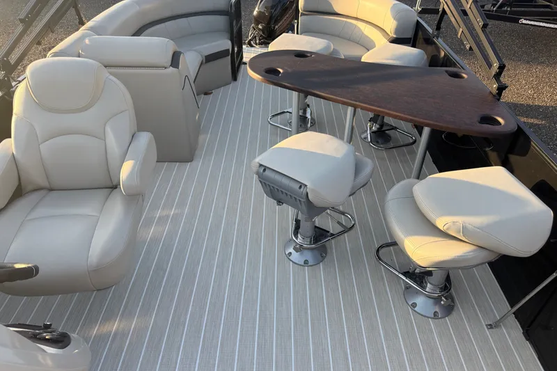 Slide: The Image of Luxurious interior of 2019 South Bay 224E pontoon boat with plush seating and table. - 9