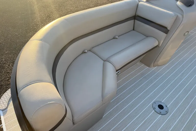 Slide: The Image of Luxurious seating on 2019 South Bay 224E pontoon boat with beige upholstery. - 17