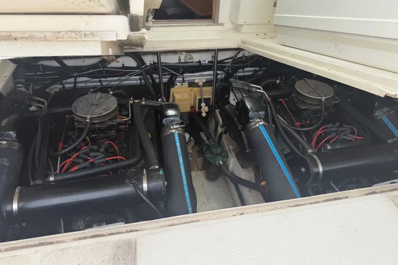 Slide: The Image of Engine compartment of a 1996 Pursuit 3100 Express boat, showcasing dual engines and wiring. - 8