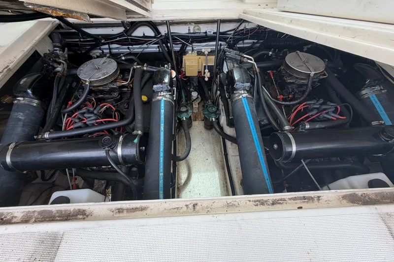 Slide: The Image of Engine compartment of a 1996 Pursuit 3100 Express boat, showcasing dual engines and components. - 7