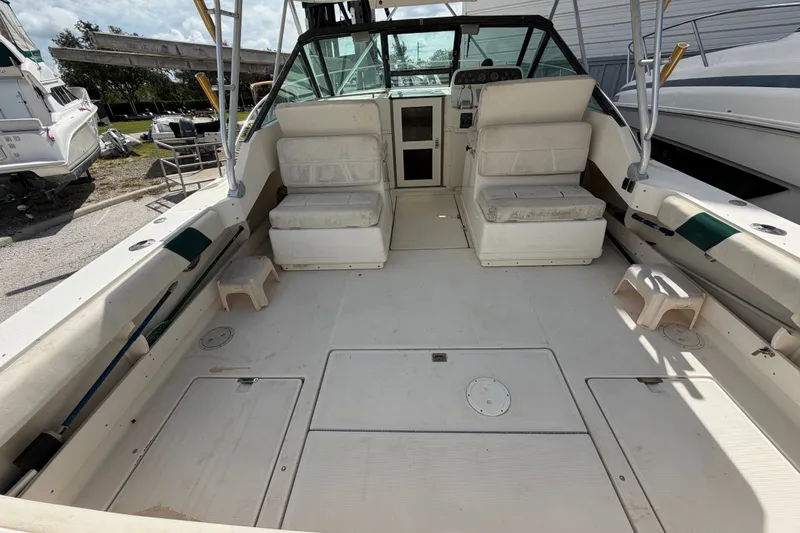 Slide: The Image of 1996 Pursuit 3100 Offshore boat interior with seating and open deck space. - 5