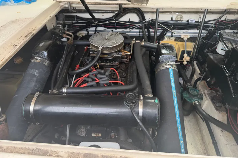 Slide: The Image of Engine compartment of a 1996 Pursuit 3100 Express boat, showcasing detailed mechanical components. - 9