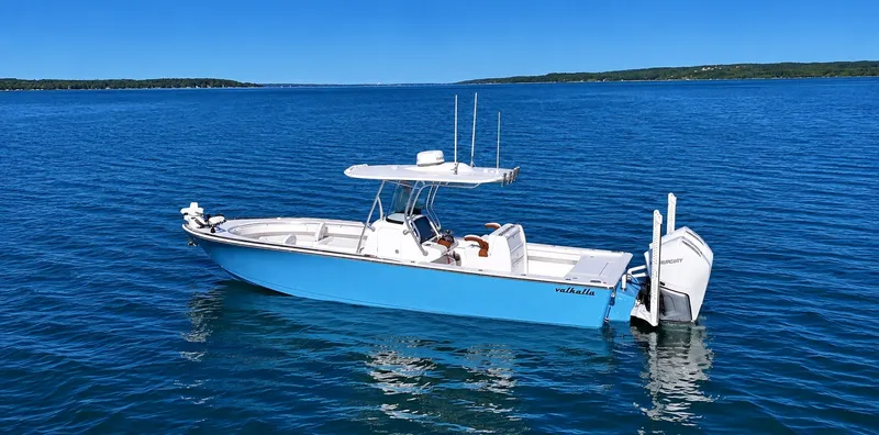 Slide: The Image of Valhalla V-29 Hybrid 2025: Sleek blue boat on calm water with modern features. - 13