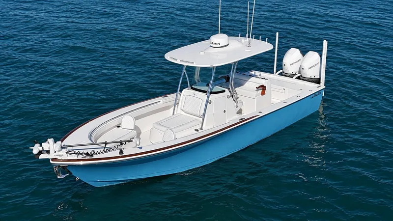 Slide: The Image of A 2025 Valhalla V-29 Hybrid on calm water. It features a blue hull design and twin outboard engines. - 3
