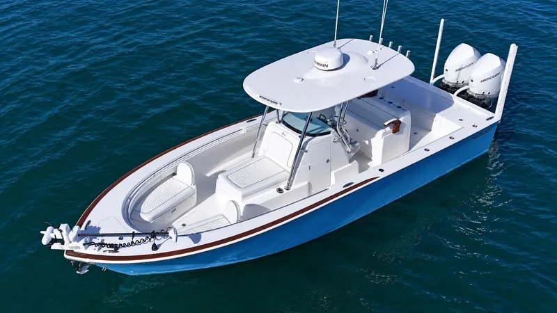 Slide: The Image of A modern boat with a blue hull and white deck, equipped with two outboard engines. - 8