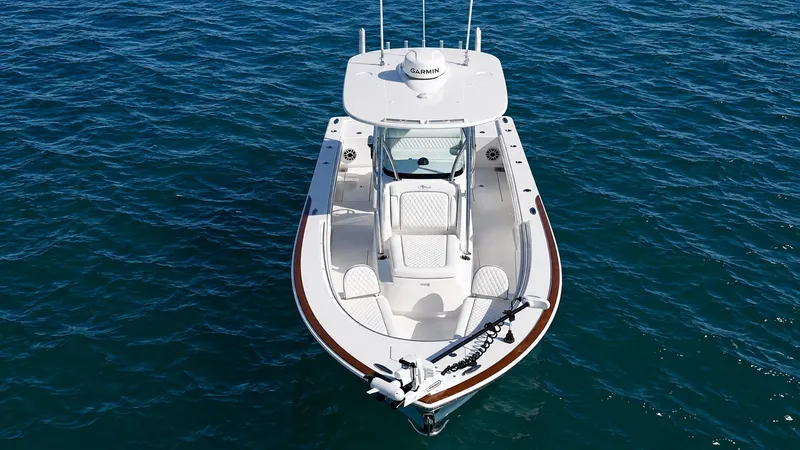 Slide: The Image of The image shows a modern boat on calm water. It features a sleek design and is equipped with a Garmin system. - 10