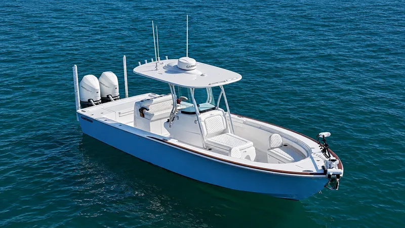 Slide: The Image of The image shows a modern boat with two outboard engines on calm water. - 6