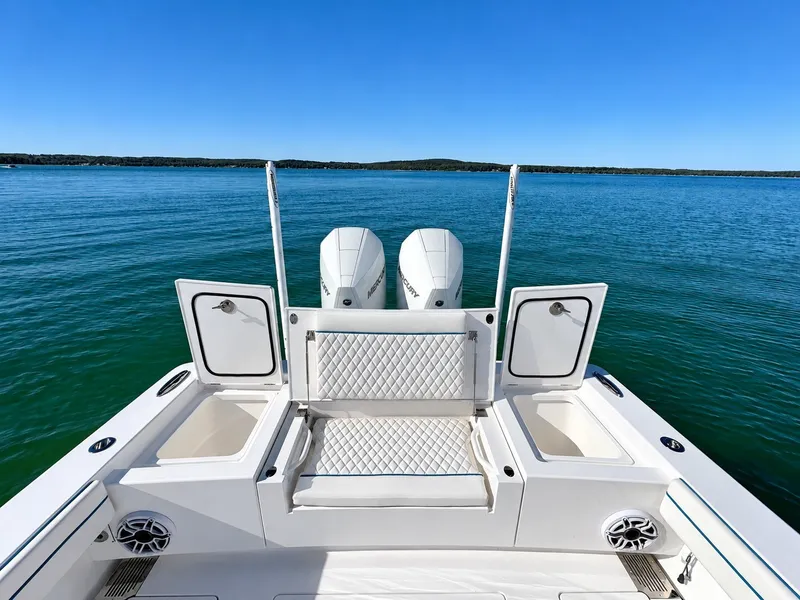 Slide: The Image of The image shows the stern of a 2025 Valhalla V-29 Hybrid on calm water. - 18