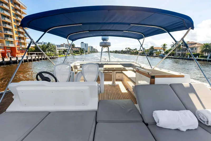 Slide: The Image of Luxury Absolute 55 FLY yacht deck with seating, 2013 model, cruising on a sunny waterway. - 29