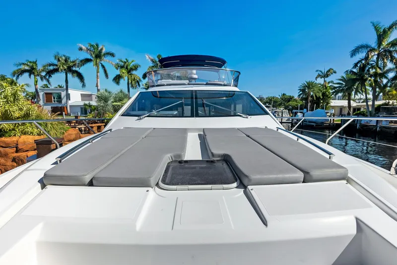 Slide: The Image of Luxury Absolute 55 FLY yacht, 2013 model, docked near palm trees. - 25