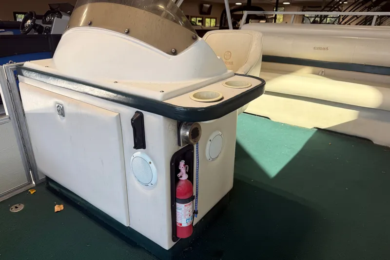 Slide: The Image of 1999 Crest II boat interior with console, cup holders, and fire extinguisher. - 11