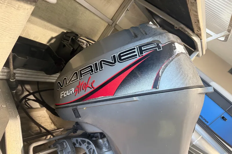 Slide: The Image of Mariner Four Stroke outboard motor on a 1999 Crest II boat. - 2