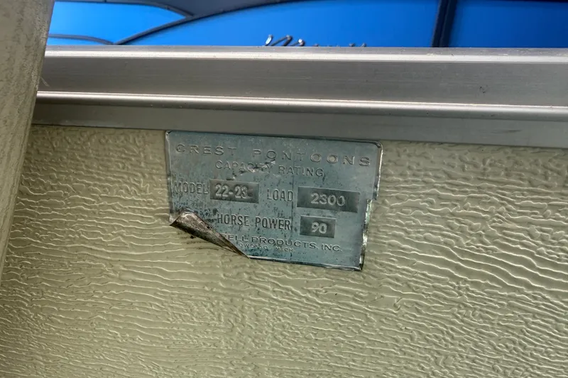Slide: The Image of Metal plate on Crest Pontoon boat, model 22-23, 2300 load capacity, 90 horsepower. - 15