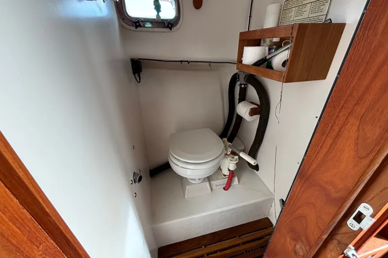Slide: The Image of 1993 Webbers Cove Pemaquid Beach 26 boat bathroom with toilet and wooden shelving. - 19