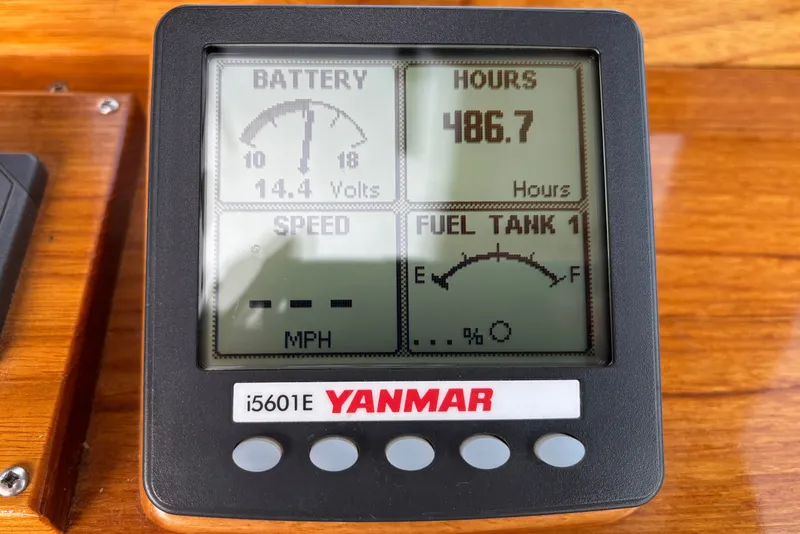 Slide: The Image of Yanmar i5601E display showing battery voltage, engine hours, and fuel level on a boat. - 26