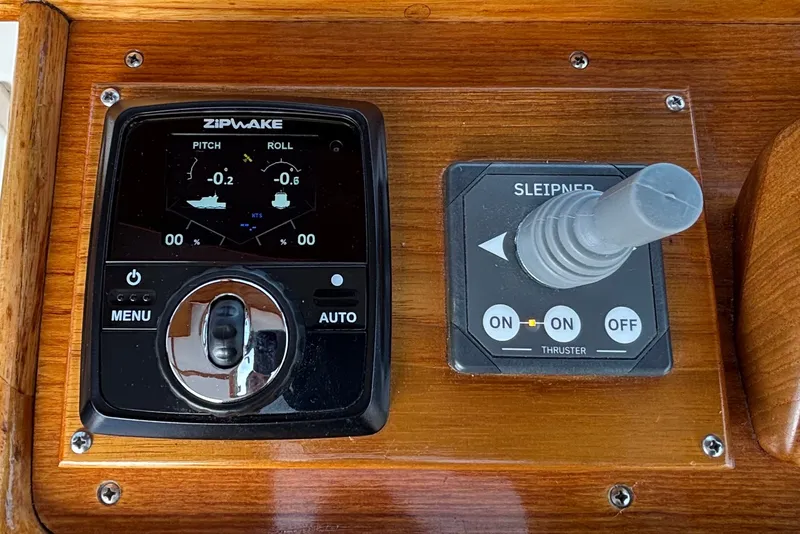 Slide: The Image of Control panel of a 1993 Webbers Cove Pemaquid Beach 26 boat, featuring Zipwake and Sleipner systems. - 28