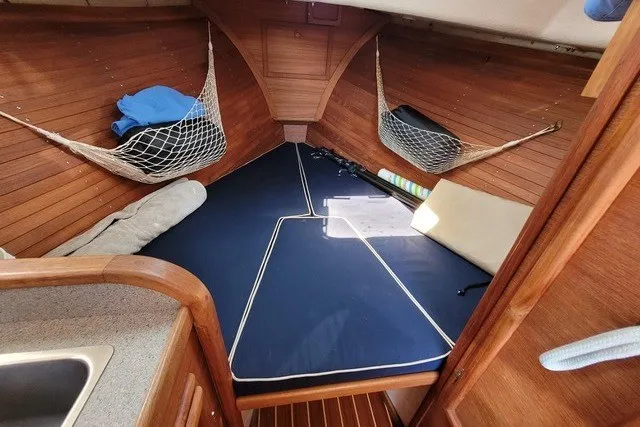 Slide: The Image of Cozy cabin interior of 1993 Webbers Cove Pemaquid Beach 26 with blue cushions and storage nets. - 18