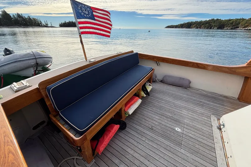 Slide: The Image of 1993 Webbers Cove Pemaquid Beach 26 boat deck with American flag and scenic water view. - 11
