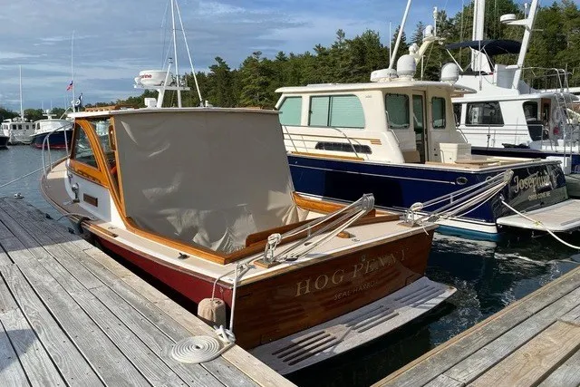 Slide: The Image of 1993 Webbers Cove Pemaquid Beach 26 boat docked at marina, featuring wooden accents and canopy. - 36