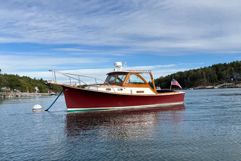Slide: The Image of Webbers Cove Pemaquid Beach 26 boat, 1993 model, anchored in scenic waters with American flag. - 7