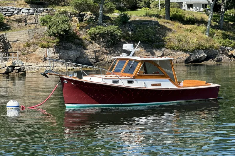 Slide: The Image of 1993 Webbers Cove Pemaquid Beach 26 boat moored on calm water near rocky shoreline. - 2