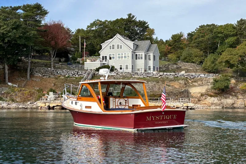 Slide: The Image of A 1993 Webbers Cove Pemaquid Beach 26 boat named "Mystique" on calm waters near a coastal home. - 3