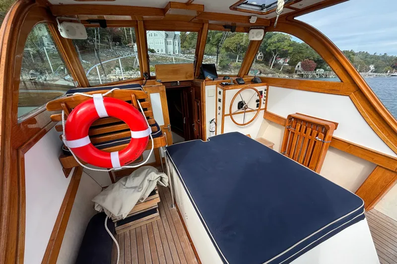 Slide: The Image of Interior of a 1993 Webbers Cove Pemaquid Beach 26 boat with wooden accents and a life preserver. - 13