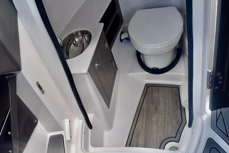 Slide: The Image of 2025 Monterey 275SS Super Sport boat bathroom with toilet and sink. - 62