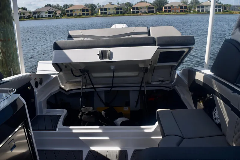 Slide: The Image of 2025 Monterey 275SS Super Sport boat interior with open storage compartment by the water. - 102