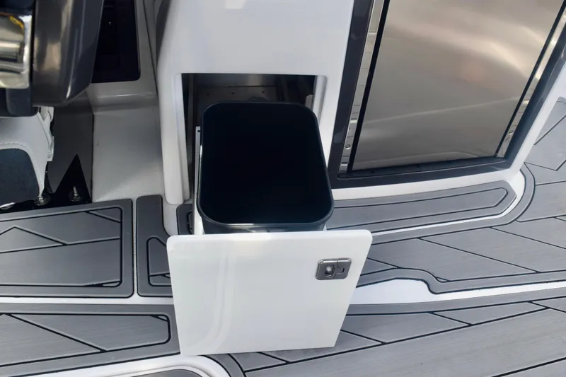 Slide: The Image of 2025 Monterey 275SS Super Sport boat interior with open storage compartment and sleek flooring. - 52