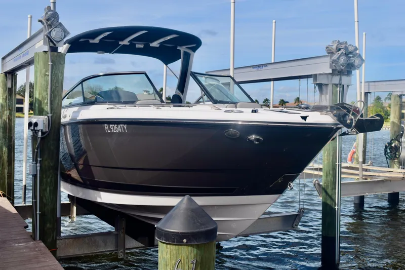 Slide: The Image of 2025 Monterey 275SS Super Sport boat on lift at marina dock. - 3