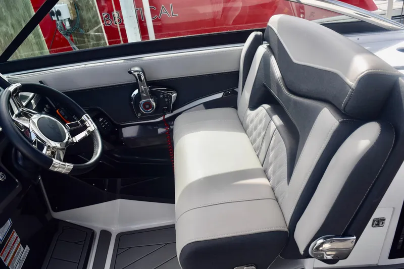 Slide: The Image of Interior of 2025 Monterey 275SS Super Sport boat with sleek steering and seating. - 53