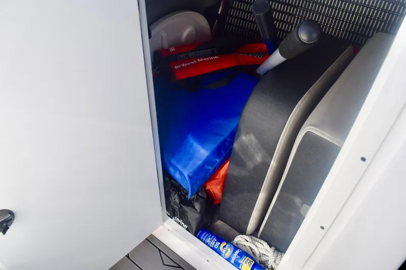 Slide: The Image of Storage compartment in 2025 Monterey 275SS Super Sport boat with life jackets and accessories. - 97