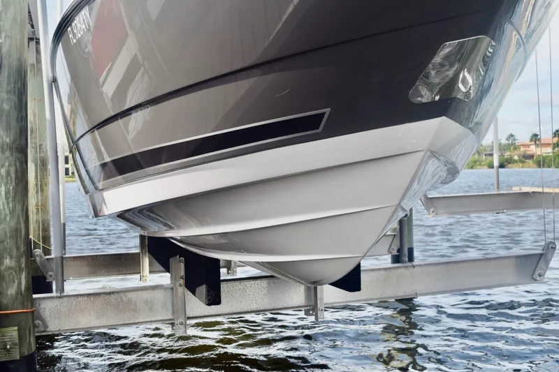 Slide: The Image of 2025 Monterey 275SS Super Sport boat hull on lift by water. - 6