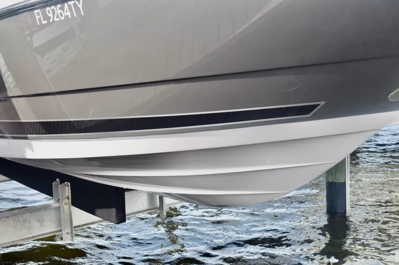 Slide: The Image of 2025 Monterey 275SS Super Sport boat hull on lift above water. - 5