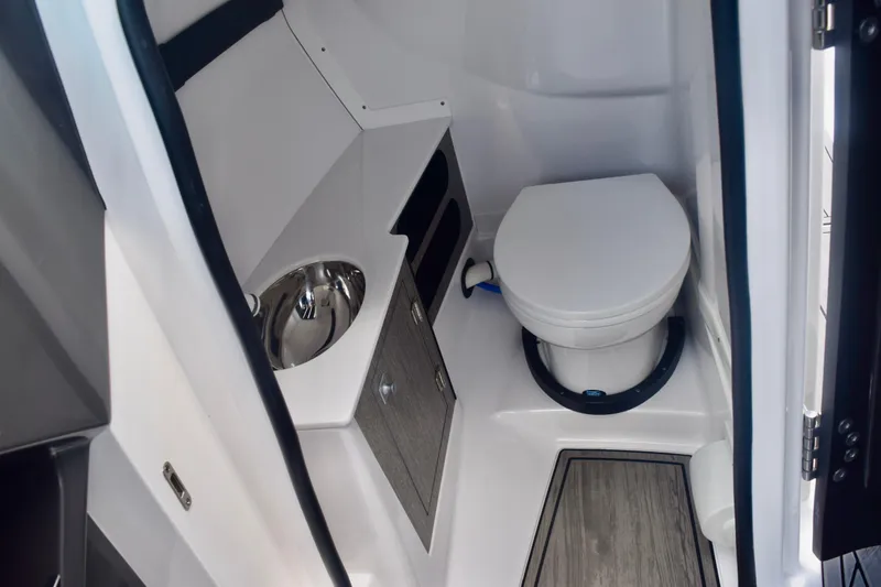 Slide: The Image of 2025 Monterey 275SS Super Sport boat interior bathroom with toilet and sink. - 61