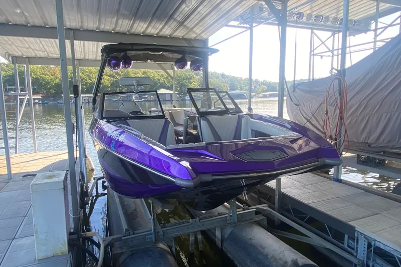 Slide: The Image of 2017 Tigé RZX3 boat in a dock, featuring a sleek purple design. - 30