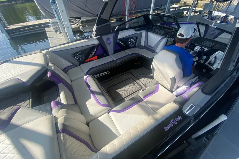 Slide: The Image of 2017 Tigé RZX3 boat interior with luxurious seating and modern dashboard. - 22