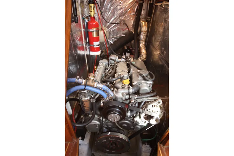 Slide: The Image of Engine compartment of a 2001 Outbound 44/46 yacht, featuring detailed mechanical components. - 39