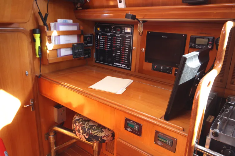 Slide: The Image of Navigation station of 2001 Outbound 44/46 yacht with control panels and equipment. - 12