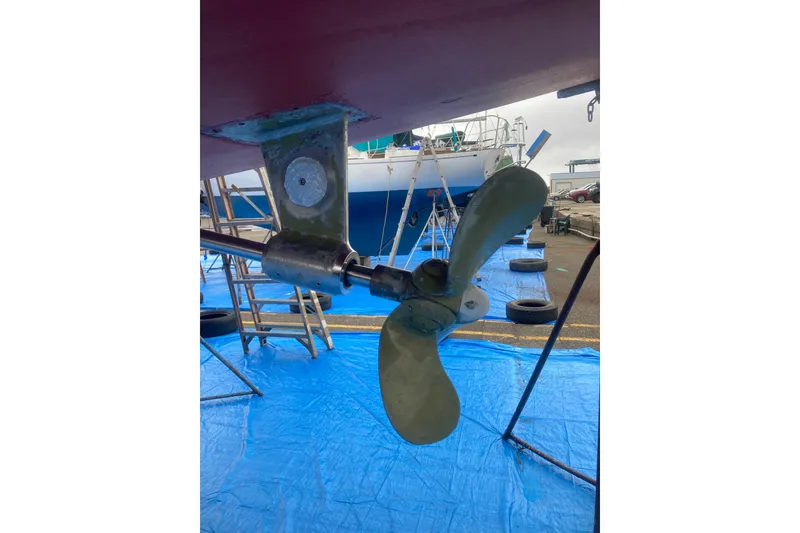 Slide: The Image of Propeller of 2001 Outbound 44/46 sailboat on dry dock with blue tarp. - 54