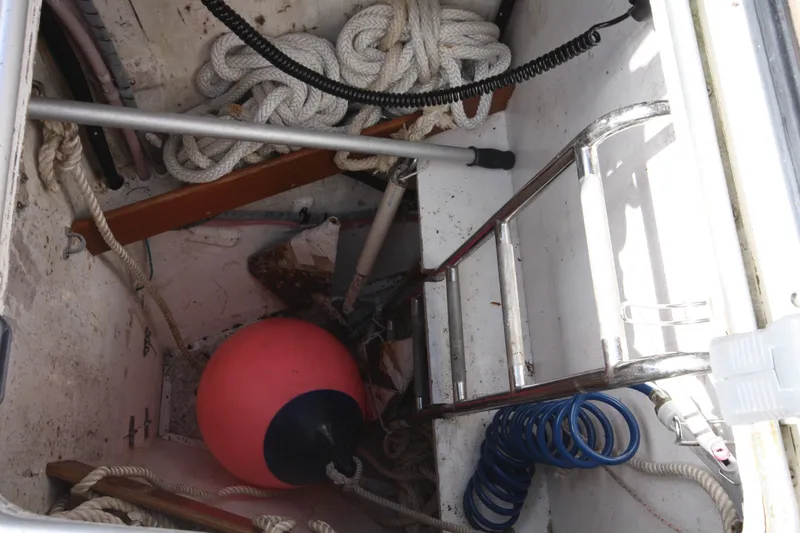 Slide: The Image of Storage compartment of 2001 Outbound 44/46 sailboat with ropes, buoy, and ladder. - 41