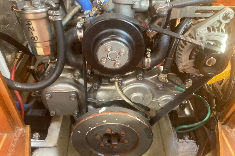 Slide: The Image of Engine compartment of a 2001 Outbound 44/46 sailboat, showing belts and components. - 31