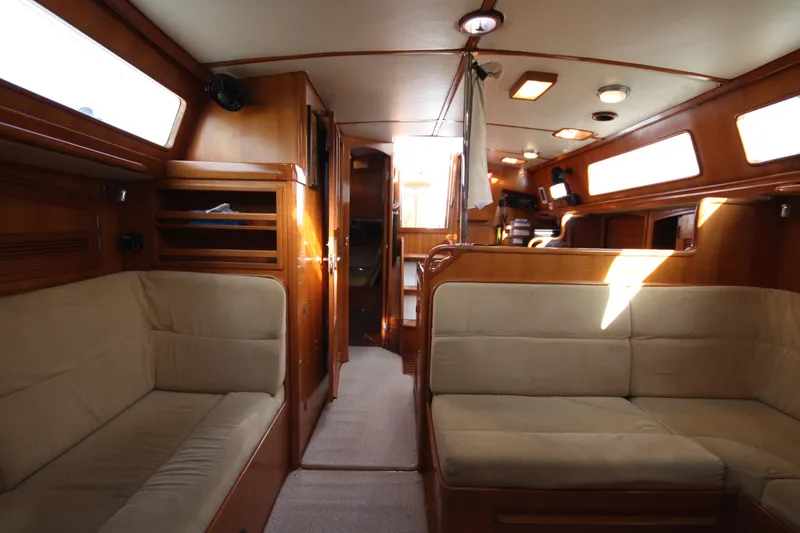 Slide: The Image of Interior of 2001 Outbound 44/46 yacht with wooden finish and beige seating. - 10