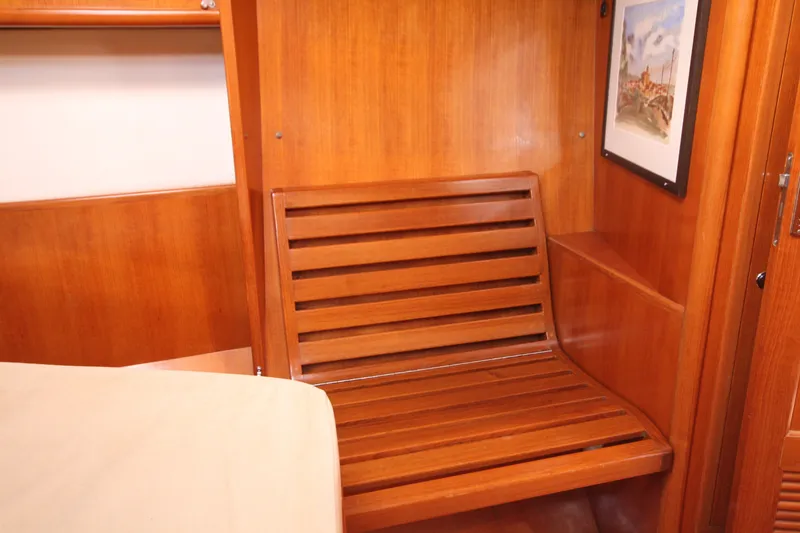 Slide: The Image of Wooden interior of 2001 Outbound 44/46 yacht with slatted seat and wall art. - 22