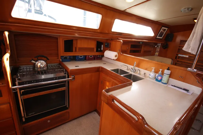 Slide: The Image of Luxurious 2001 Outbound 44/46 yacht kitchen with wooden cabinetry and modern amenities. - 9
