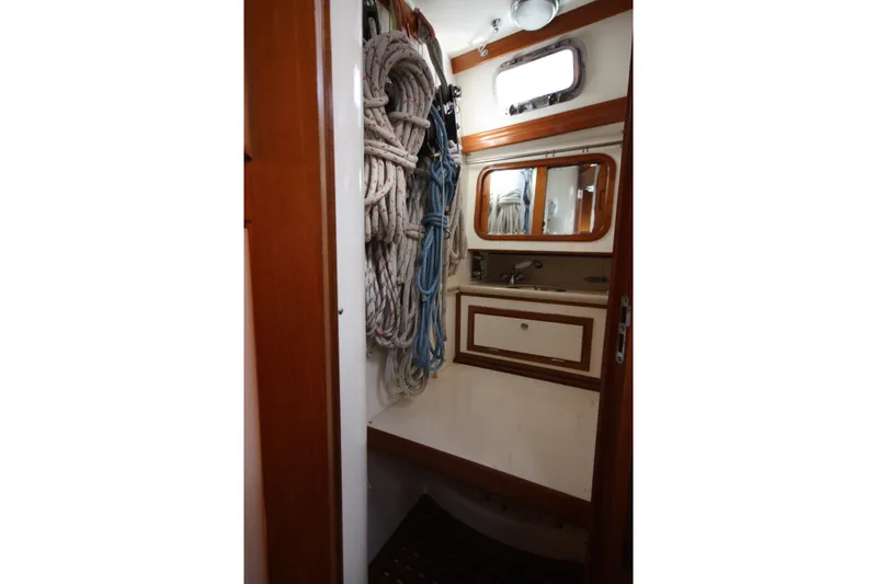 Slide: The Image of Compact bathroom on 2001 Outbound 44/46 yacht with ropes and wooden accents. - 25